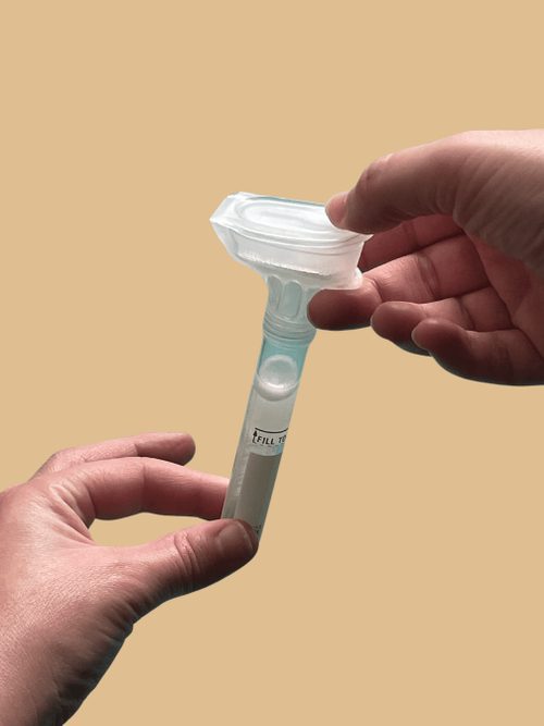 Person holding DNA collection tube