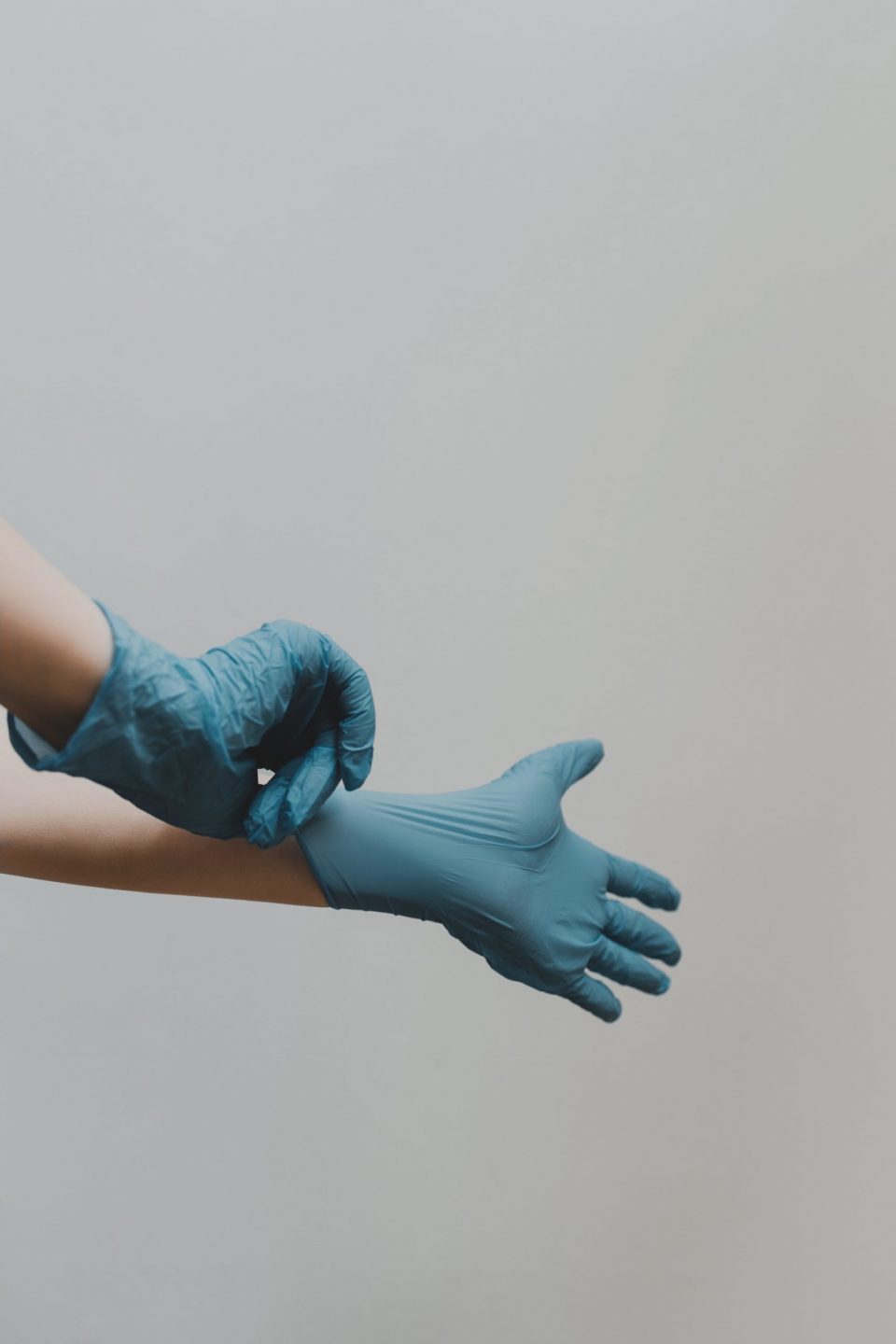 Image of person putting on surgical glovesn
