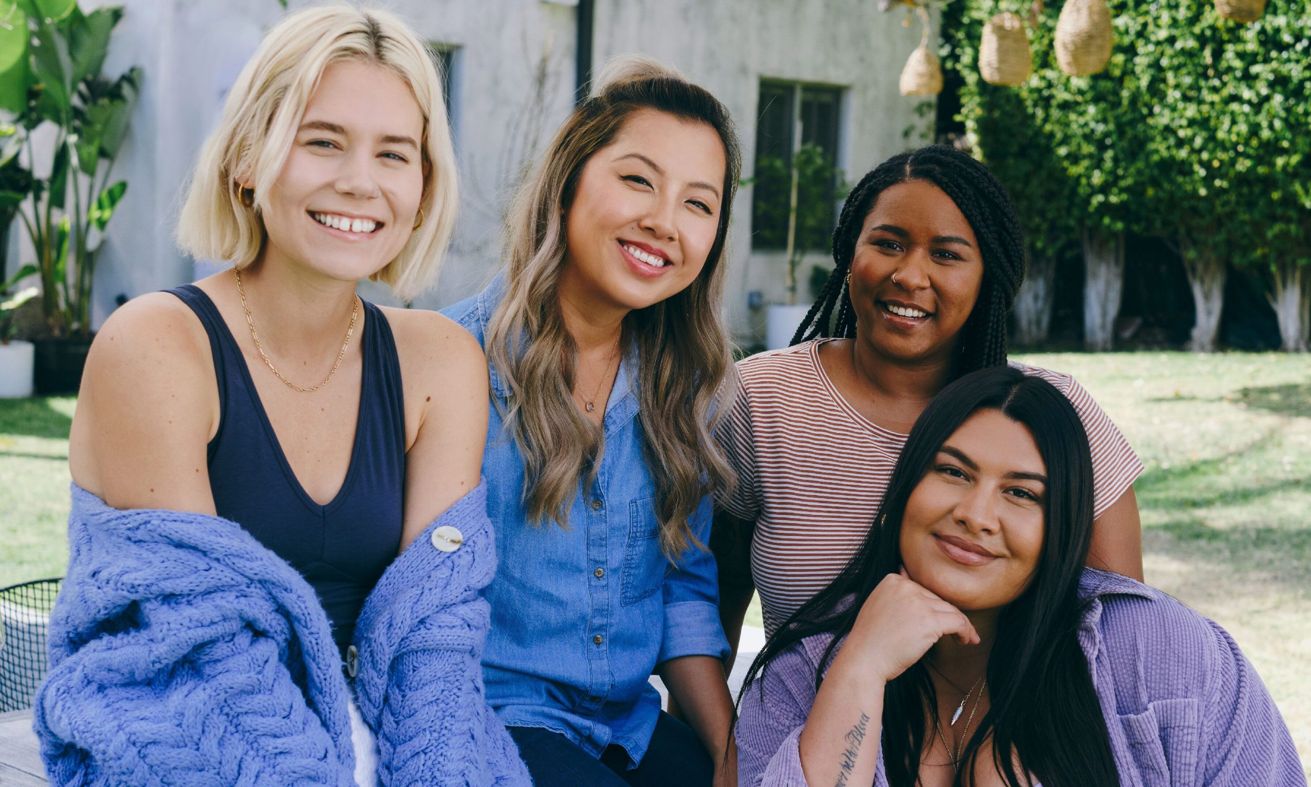 Four young women casually smiling at camera