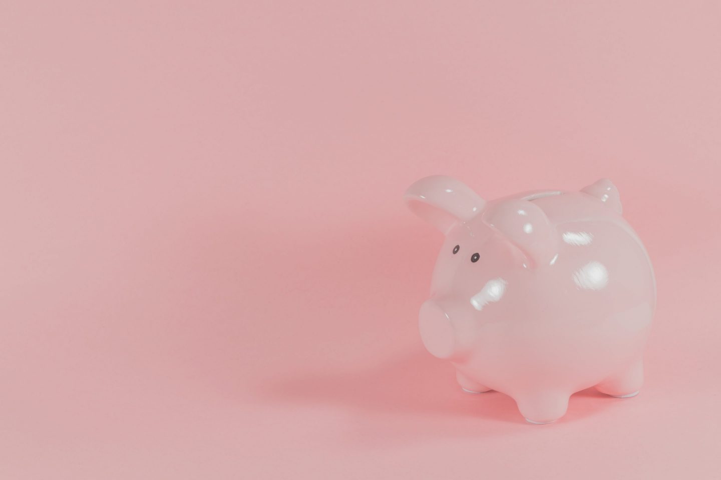 Piggy bank on pink background