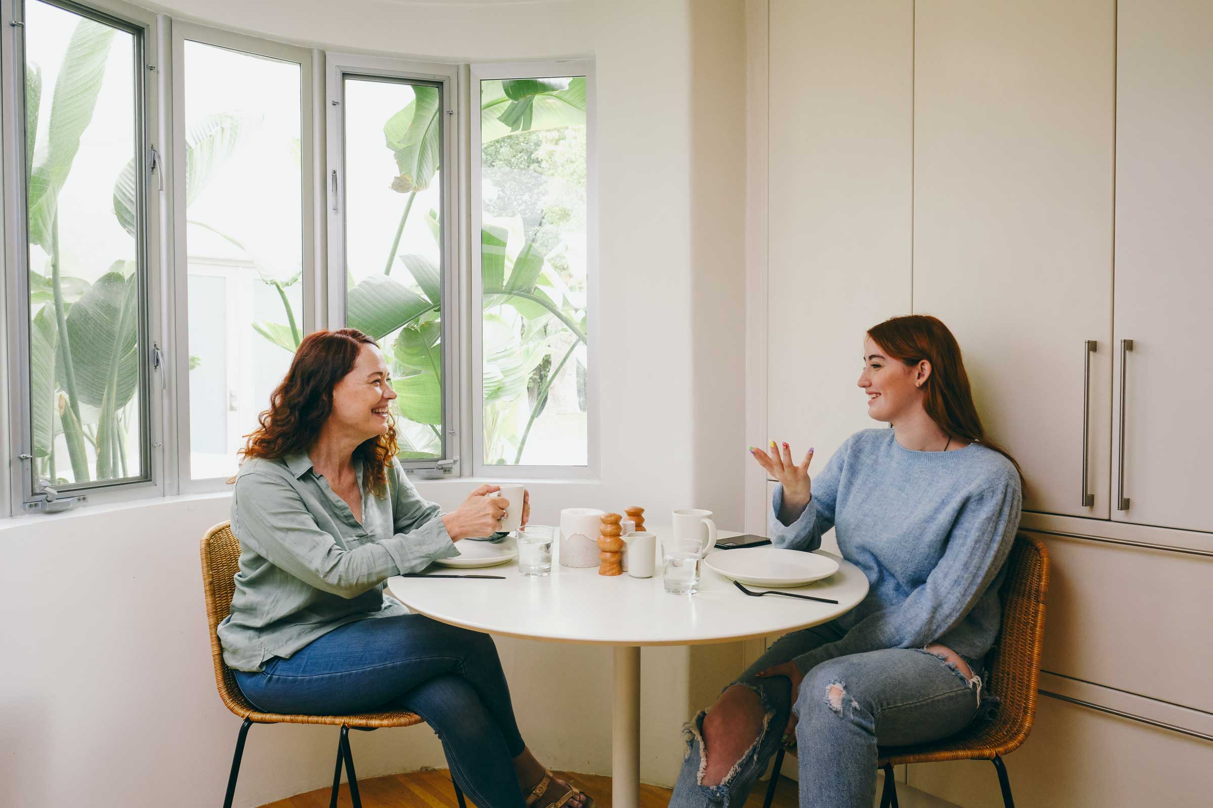 mother and daughter talking at the breakfast table