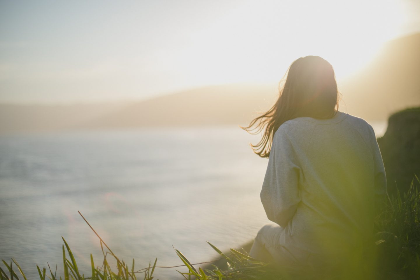 Woman staring off into the ocean